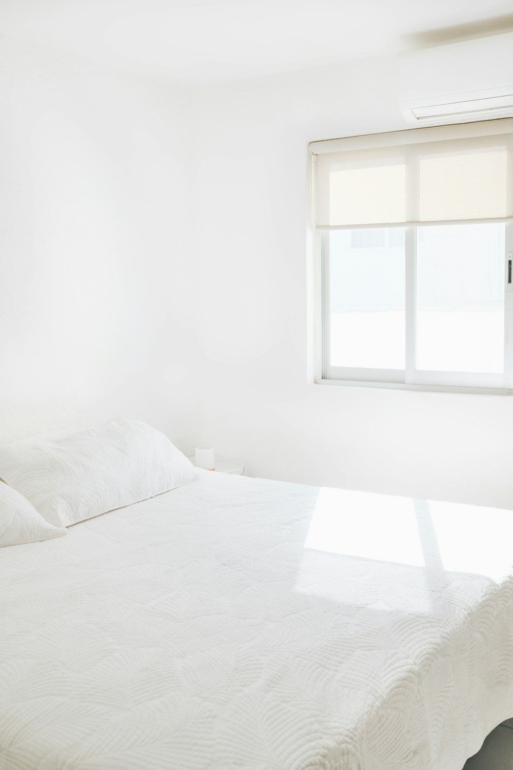 Bright, freshly made bed in a clean holiday let bedroom