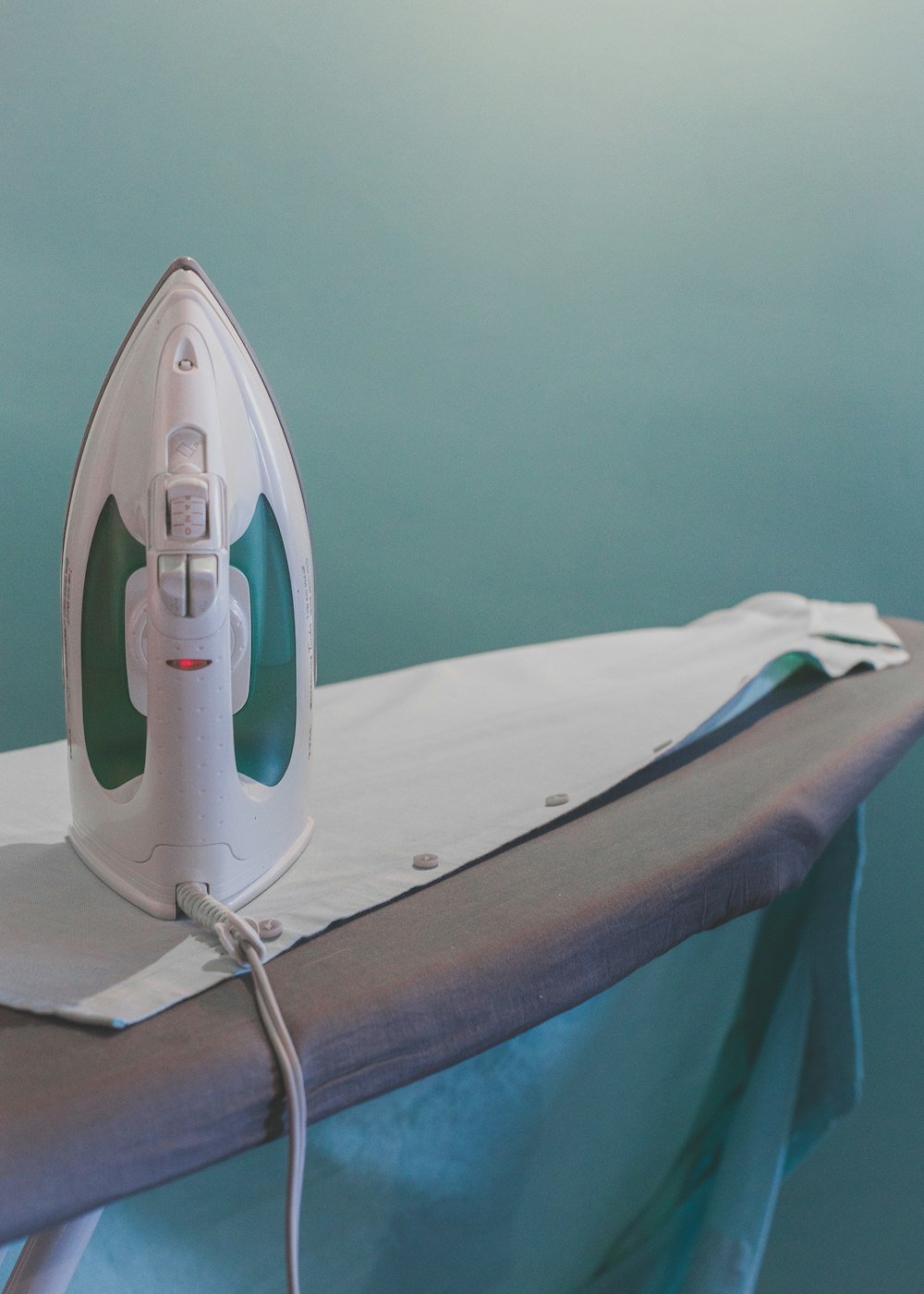 Iron resting on an ironing board
