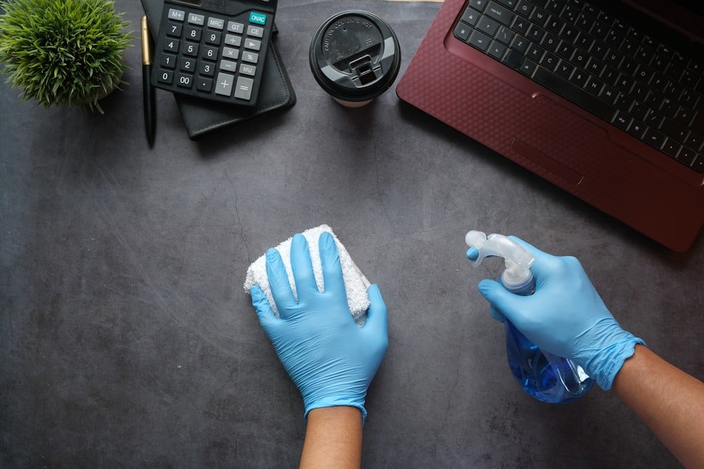 Wiping down a desk in a small office